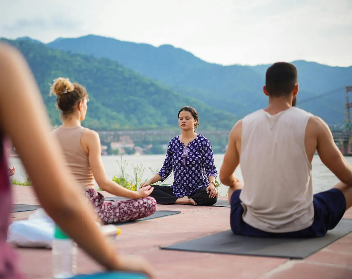 Yoga instructor teaching outdoor class
